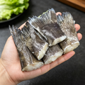 Skin-on cod tail sections laid out on a dark, cool-toned surface